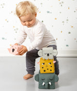 A child playing with the Roommate Jungle Life Stacking Blocks.