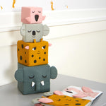 The Roommate Jungle Life Stacking Blocks shown stacked on a grey coloured surface. 