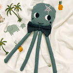 A Roommate octopus rag doll on a patterned duvet cover. 