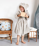 A child wearing the Roommate organic cotton bathrobe with a mouse design. 