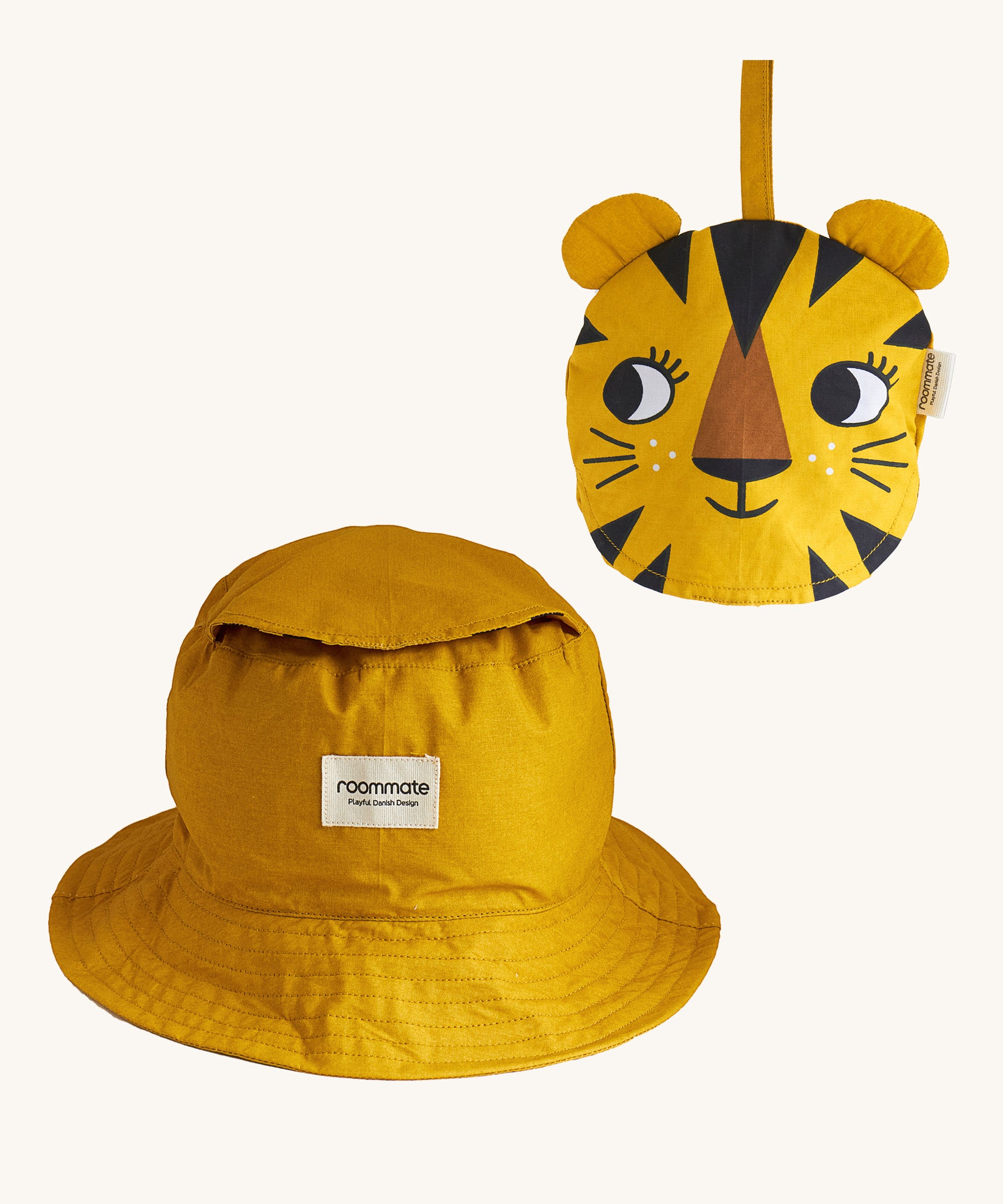 Two Roommate Tiger bucket hats, one is opened up into the bucket hat form, and another is folded into itself to create a tiger face. 