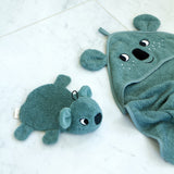 Roommate organic cotton koala washcloth bath toy placed beside a matching koala hooded towel on a pale surface, showing coordinating bathroom textiles from the Roommate range.