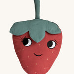 Roommate Organic Cotton Strawberry Cushion. A fun, soft Strawberry cushion with a red fruit body with big eyes and a smiling mouth, and green leafy top on a cream background