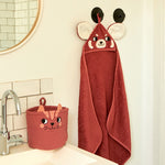 The Roommate kids red panda hooded towel, hanging in a bathroom. 