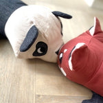 A close up of the Roommate panda and red panda long cushions touching eachother.