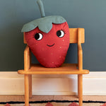  soft Strawberry cushion with a red fruit body with big eyes and a smiling mouth