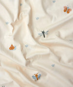 Roommate single organic cotton duvet set with a baby bugs print on a cream background. Close up of the print featuring bugs and butterflies.