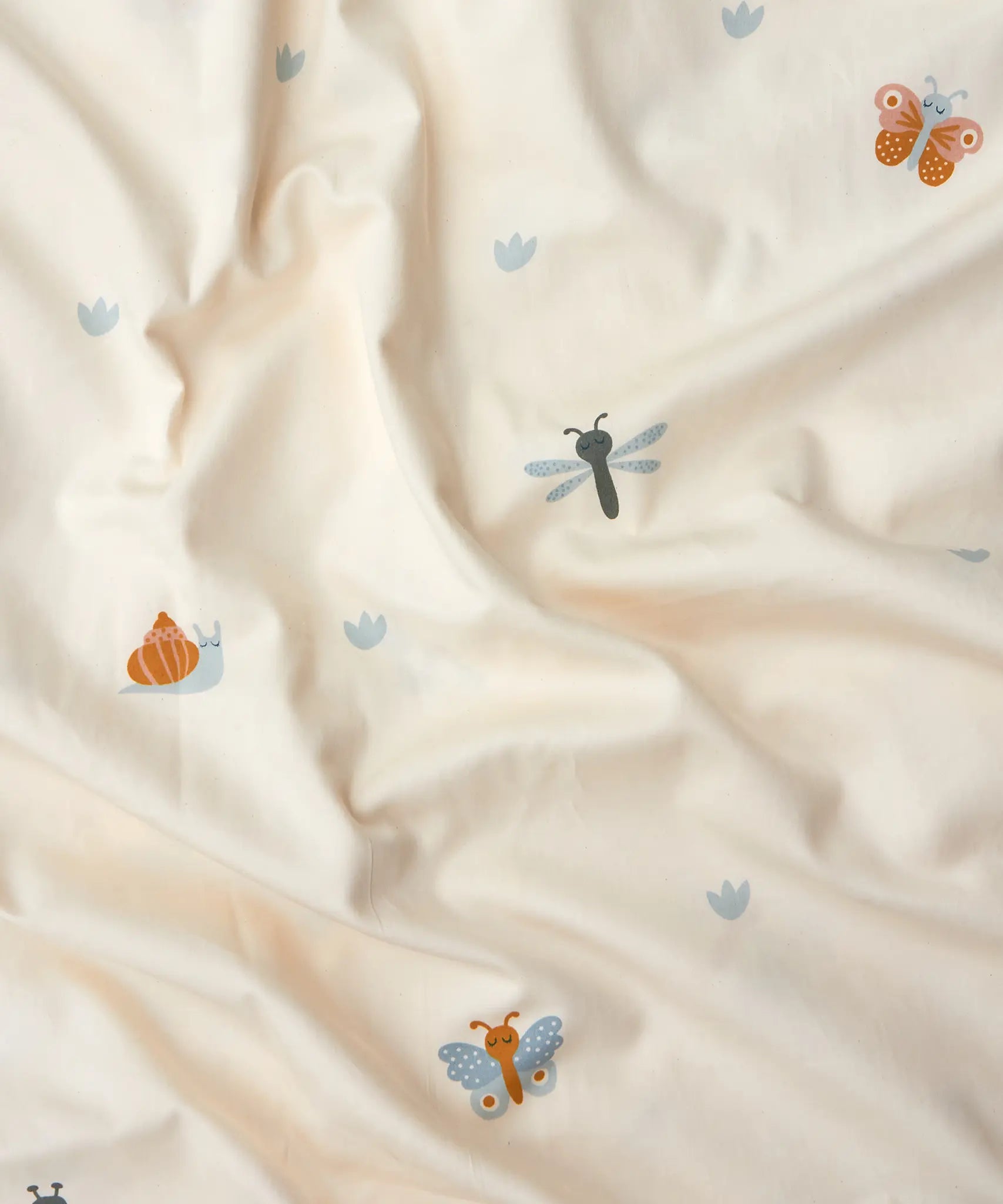 Roommate single organic cotton duvet set with a baby bugs print on a cream background. Close up of the print featuring bugs and butterflies.