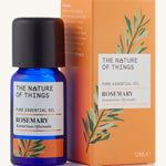 Organic Rosemary pure essential oil in a blue glass bottle in front of a decorative orange cardboard box.