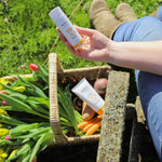 A person holding the Green People Natural and Organic Mineral Suncream SPF30 Scent Free bottle in their hand