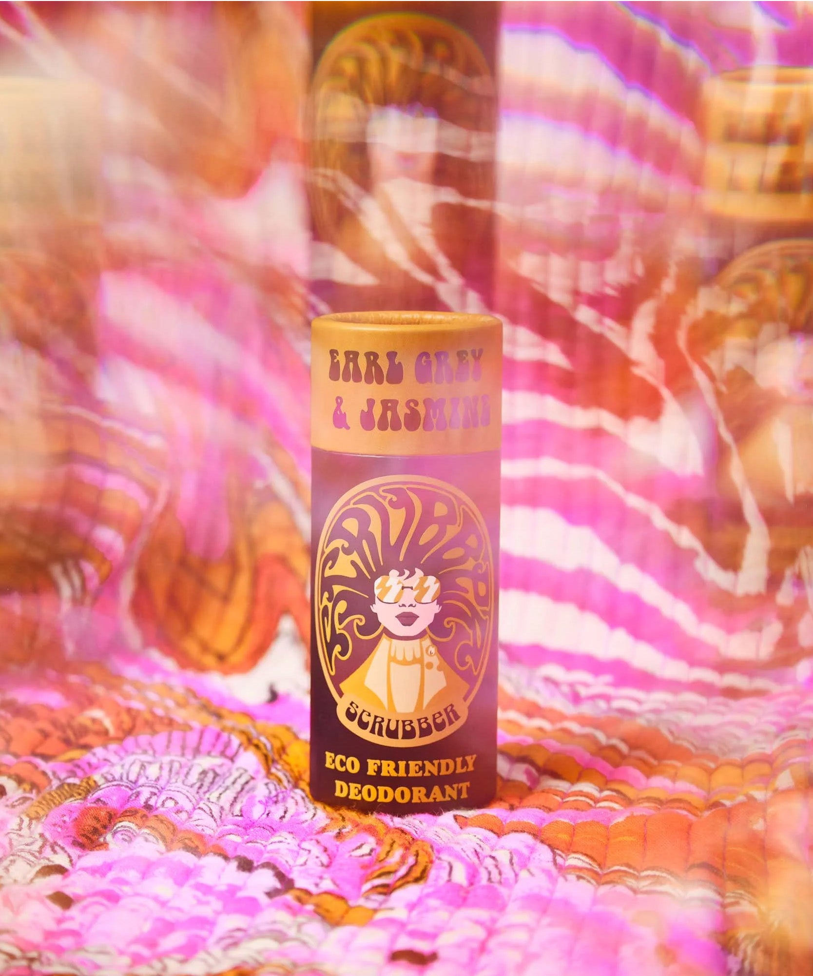 The Scrubber plastic-free natural deodorant with groovy packaging on a psychedelic background 