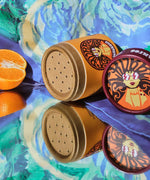 The Scrubber natural powder dry shampoo in 100% recycled cardboard packaging, on a psychedelic background 