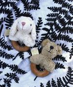 Senger bear and sheep baby grasping toys placed on an Etta Loves fern print sensory muslin cloth.