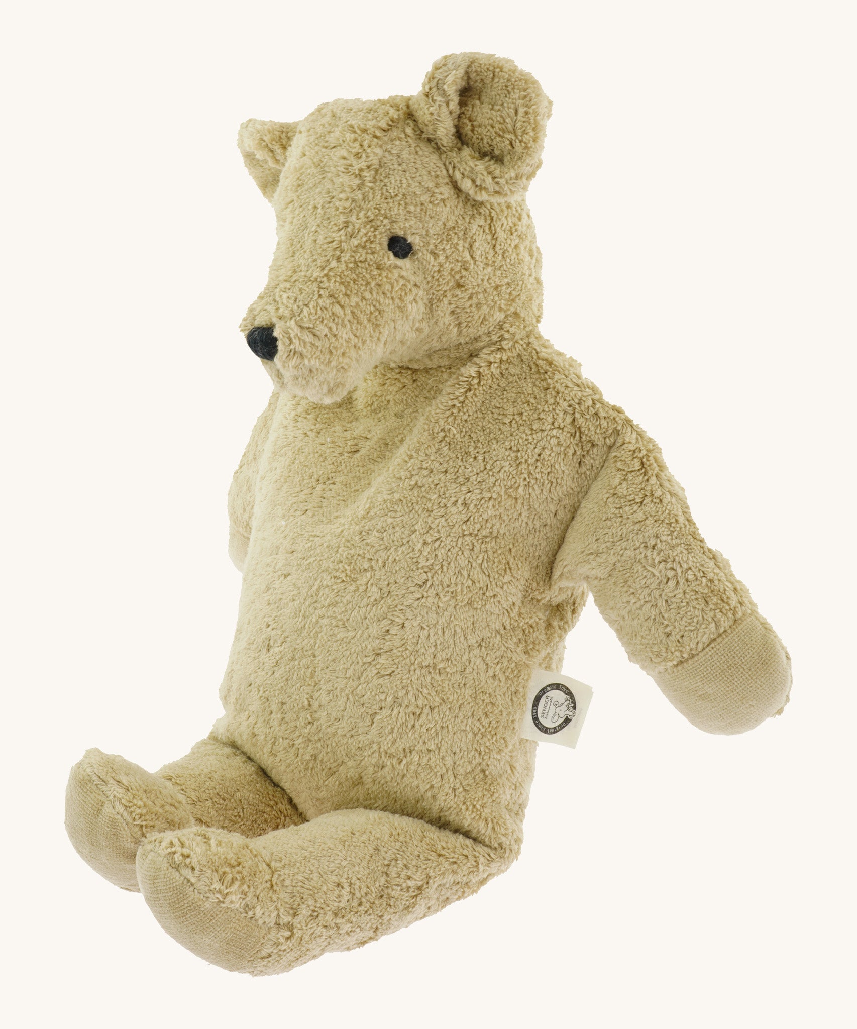 Side view of the Senger large beige bear - a GOTS organic cotton soft huggable bear showing its embroidered facial features