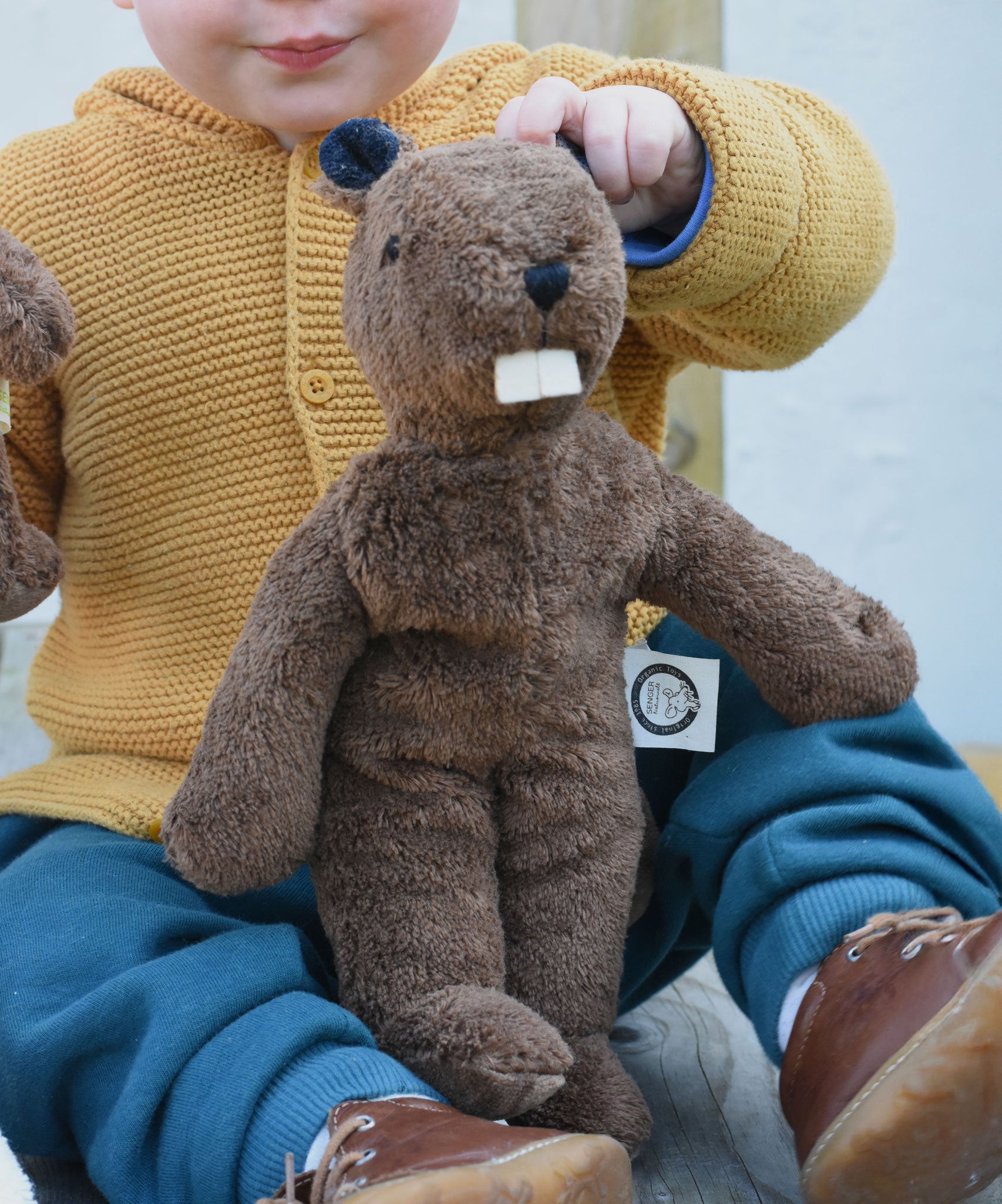 A Senger small floppy beaver on a child's lap. 