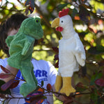 A child playing with the Senger frog and chicken puppets , one on each of their hands.