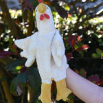 A close up of the Senger white chicken puppet in use on a child's hand.