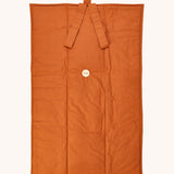 Senger cozy nap baby play mat. A padded blanket designed for babies to have a comfortable space whilst out and about. The dark orange coloured side has a button tat allows the mat to be rolled up for easy storage when not in use.