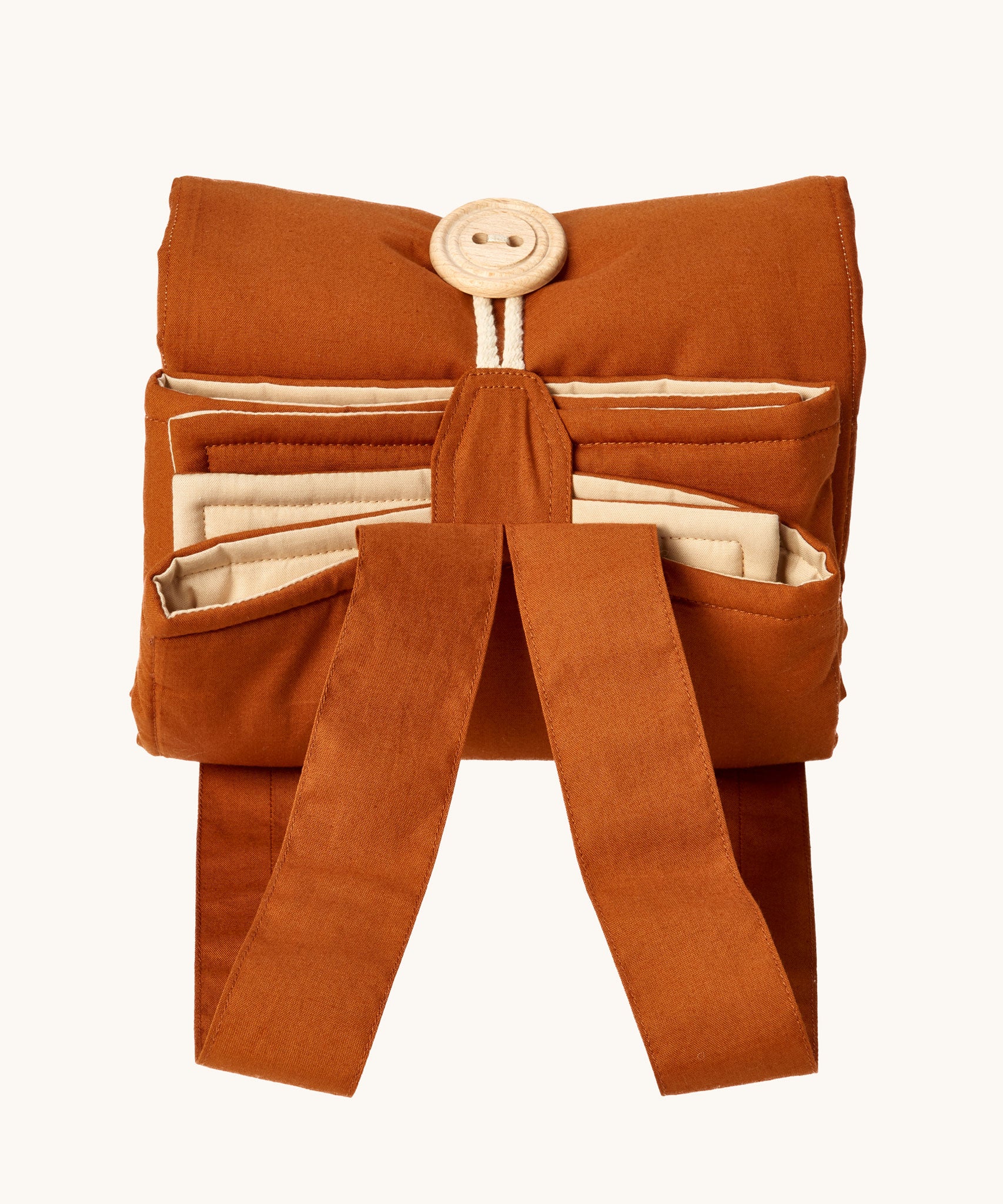 Senger cozy nap baby play mat. A padded blanket designed for babies to have a comfortable space whilst out and about. The may is shown rolled up and closed by the button and loop. 