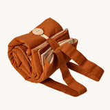 Senger cozy nap baby play mat. A padded blanket designed for babies to have a comfortable space whilst out and about. The mat is shown rolled up and secured with the button and loop. 