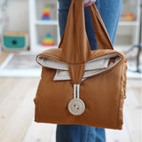 The Senger Cozy Nap playmat made from organic cotton, folded and rolled for easy transporting.