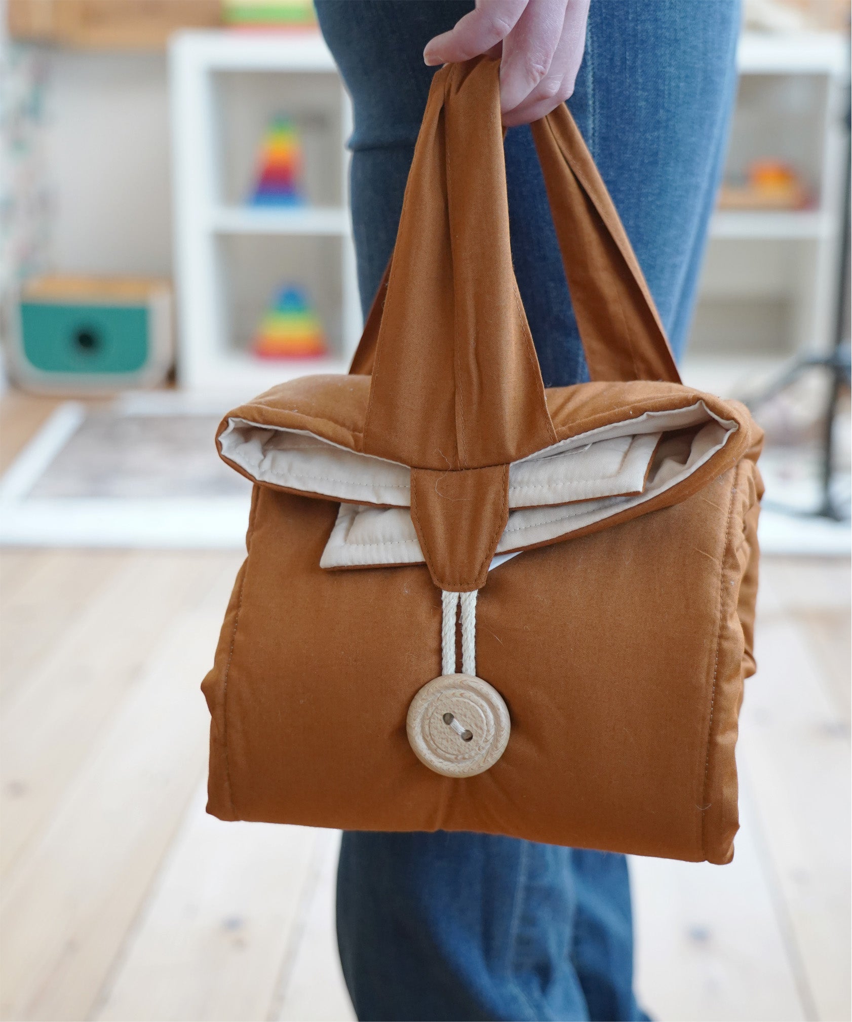 The Senger Cozy Nap playmat made from organic cotton, folded and rolled for easy transporting.