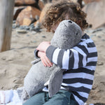 A child cuddling the large cuddly Senger grey seal. 