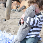 A child cuddling the large cuddly Senger grey seal. 