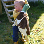 A young child carrying a Senger Large Cuddly Drake Duck soft toy.