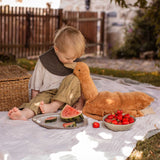 A child sitting next to a Senger Large Cuddly Goose organic soft toy in a dark orange Rust colour. These soft toys are created from the highest quality, sustainable and traceable natural materials. Senger cuddly animal toys and soft dolls are handmade in Germany with love and attention to detail and we are proud Senger stockists here at Babipur. 