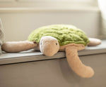 A large Senger Cuddly Green Turtle placed on a window sill. 