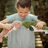 A little girls playing with two Senger cuddly fish organic stuffed toys