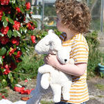 A little boy holding a mall and a large Senger organic cotton cuddly white teddy bear