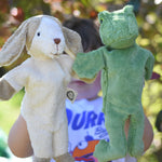 Senger dog and frog puppet toys in use on a child's hands. 