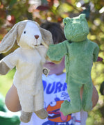 Senger dog and frog puppet toys in use on a child's hands. 