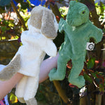 Senger dog and frog puppet toys in use on a child's hands.