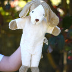 A Senger dog puppet toy in use on a child's hand. 