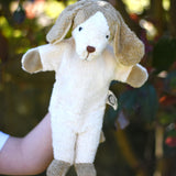 A Senger dog puppet toy in use on a child's hand. 