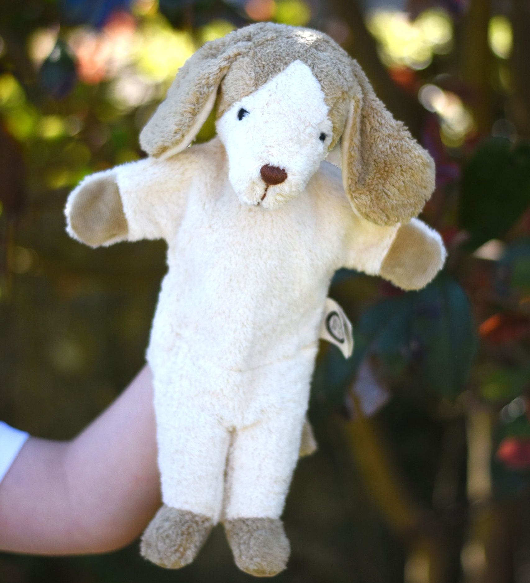 A Senger dog puppet toy in use on a child's hand. 