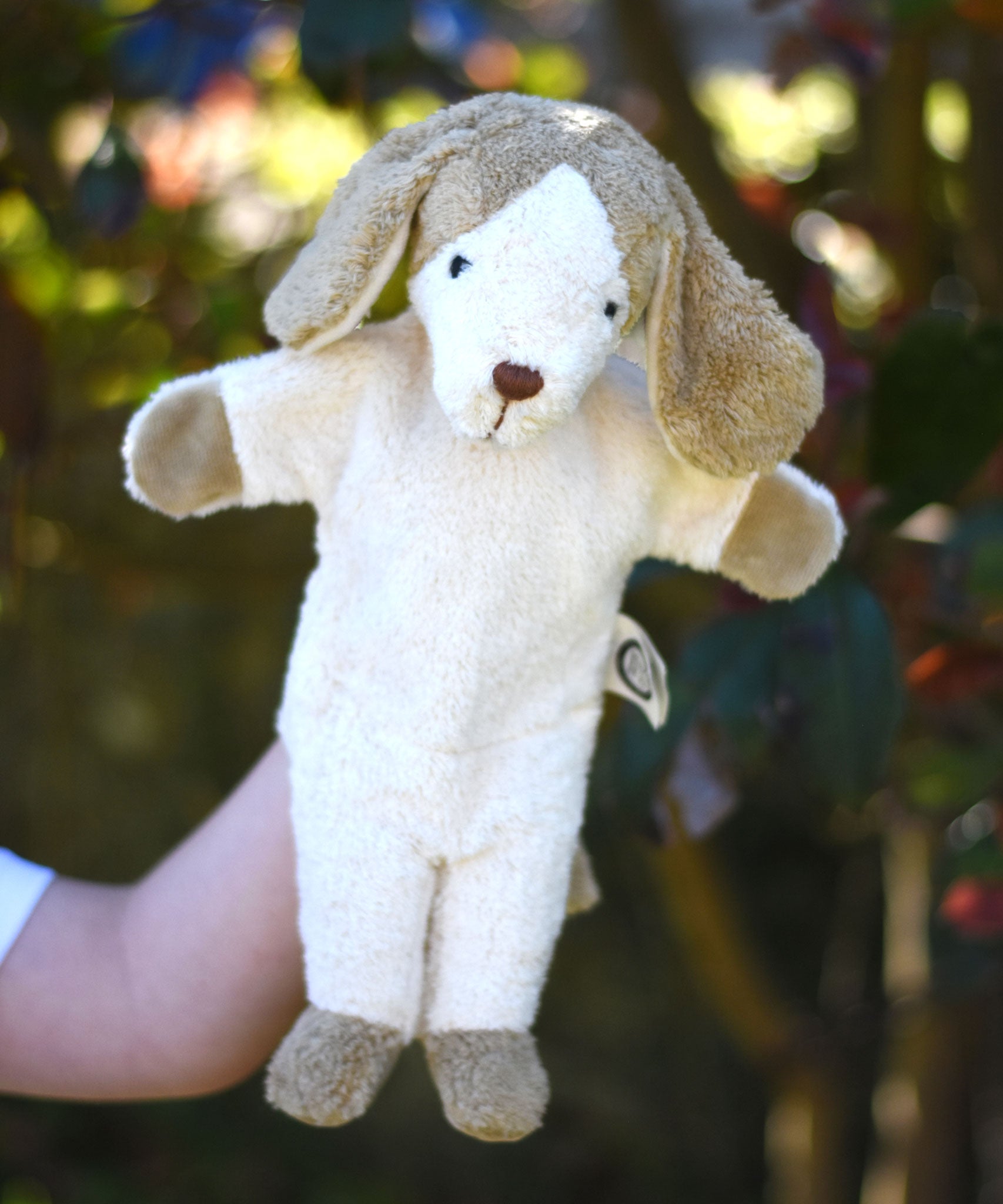 A Senger dog puppet toy in use on a child's hand. 