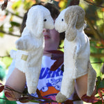 Senger dog and sheep puppet toys in use on a child's hands.