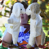 Senger dog and sheep puppet toys in use on a child's hands.