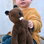 A close up of the Senger small floppy beaver, a child can be seen in the background holding it up.