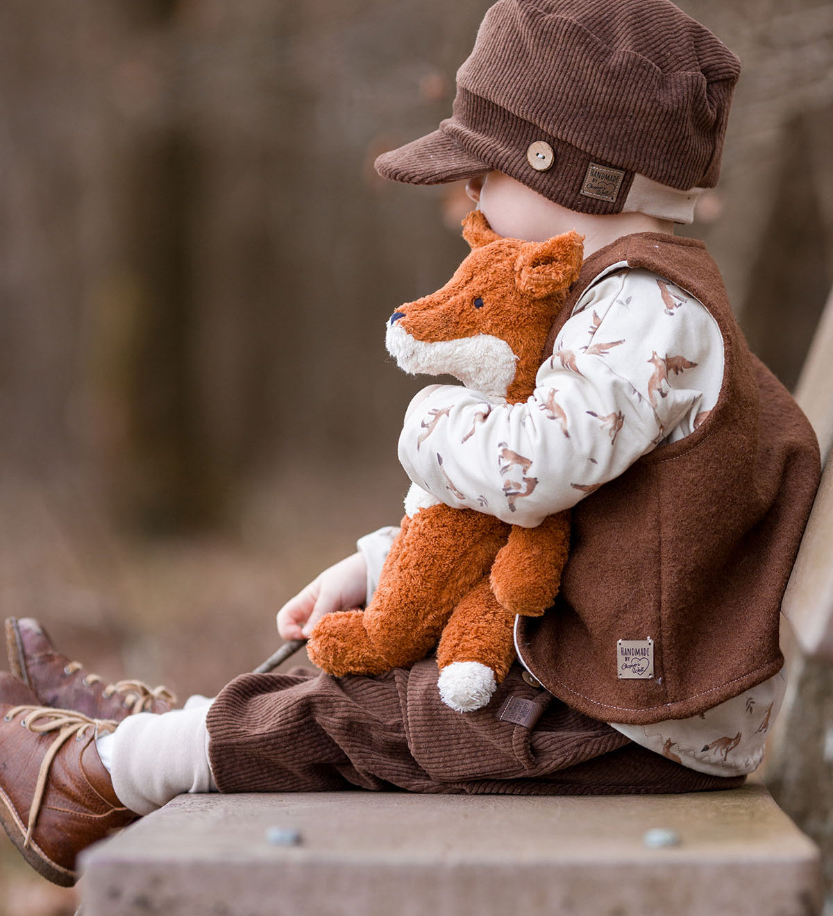 A child sitting on a bench outside
