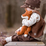 A child sitting on a bench outside