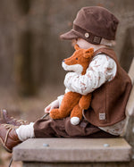 A child sitting on a bench outside
