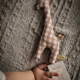 A baby's hand next to a Senger giraffe grasping toy available at Babipur showing scale of the grasping toy