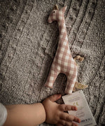 A baby's hand next to a Senger giraffe grasping toy available at Babipur showing scale of the grasping toy