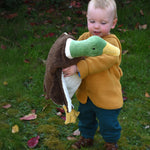 A Senger Large Cuddly Drake Duck soft toy  being carried by a young child.