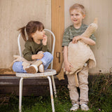 A child holding a Senger Large Cuddly Goose organic soft toy in a creamy Linen colour. Another child is sitting on a chair besides them holding the smaller version of the goose. These soft toys are created from the highest quality, sustainable and traceable natural materials. Senger cuddly animal toys and soft dolls are handmade in Germany with love and attention to detail and we are proud Senger stockists here at Babipur. 